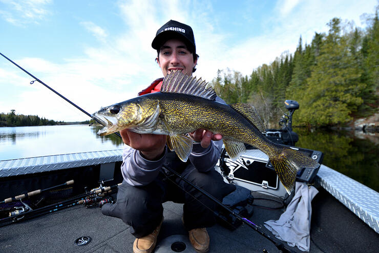 young angler fishing walleye boat