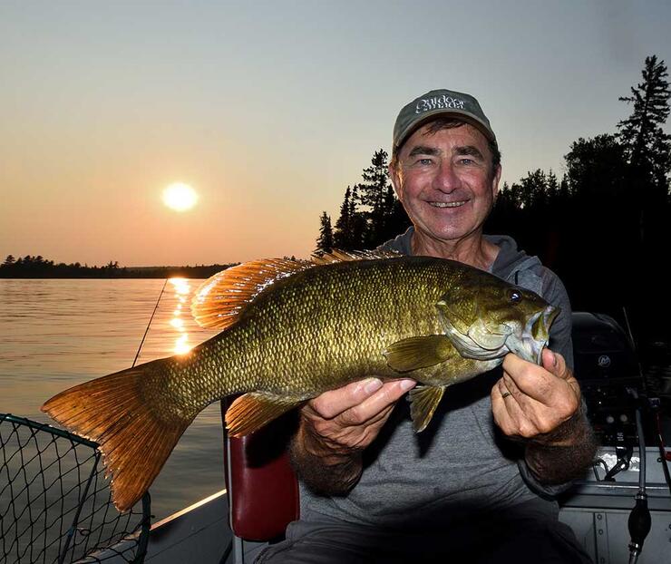 angler holding bass