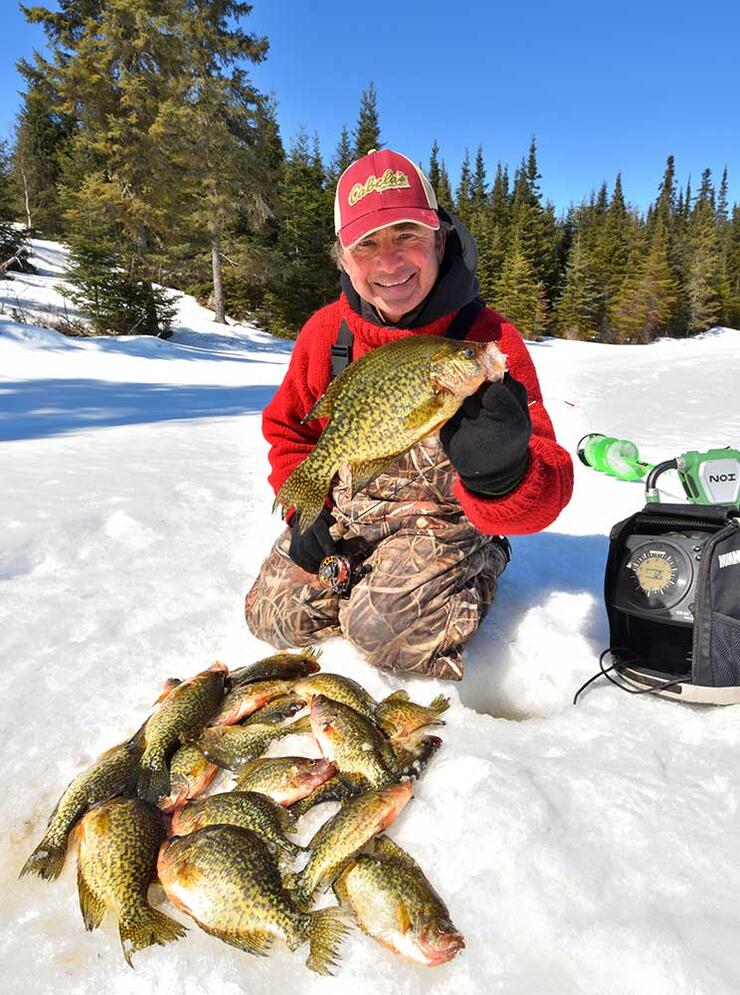 angler ice fishing black crappie