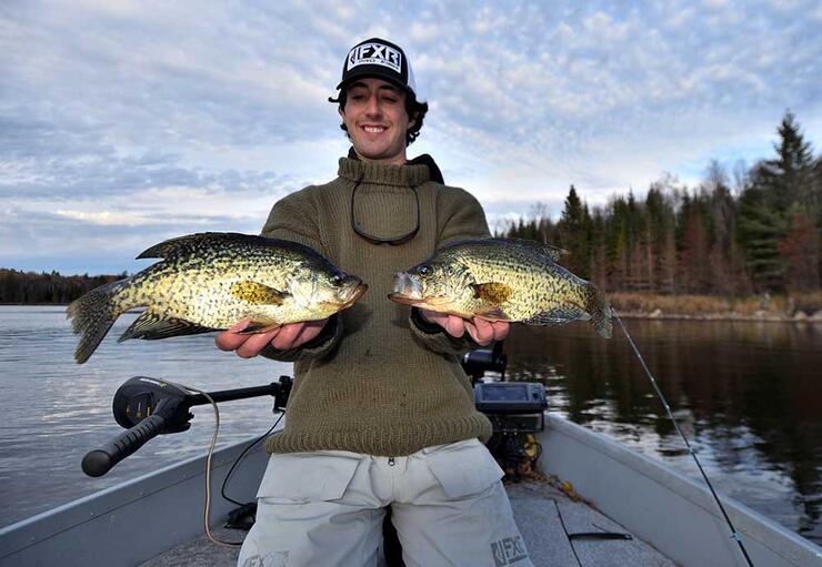 young angler holding crappie fish