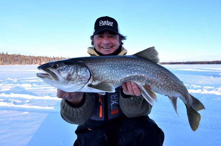 angler ice fishing lake trout