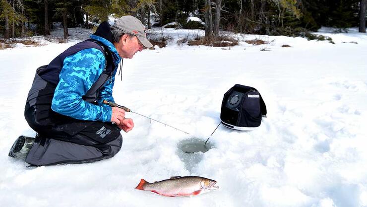 angler ice fishing trout ontario