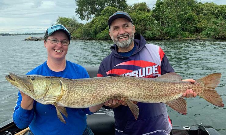 anglers holding large fish