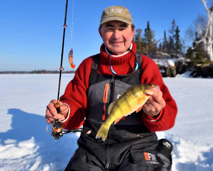 angler ice fishing perch