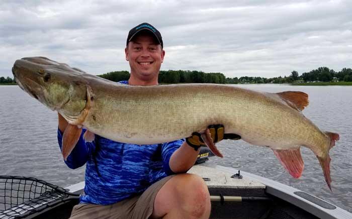 angler holding muskie