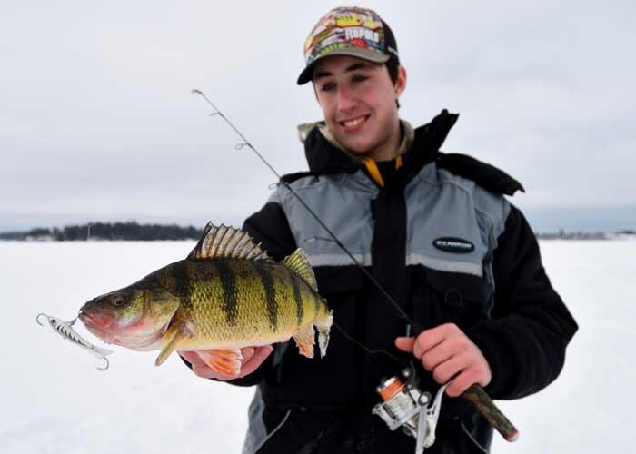 young ice angler with perch