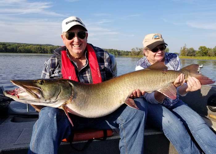 anglers holding muskie