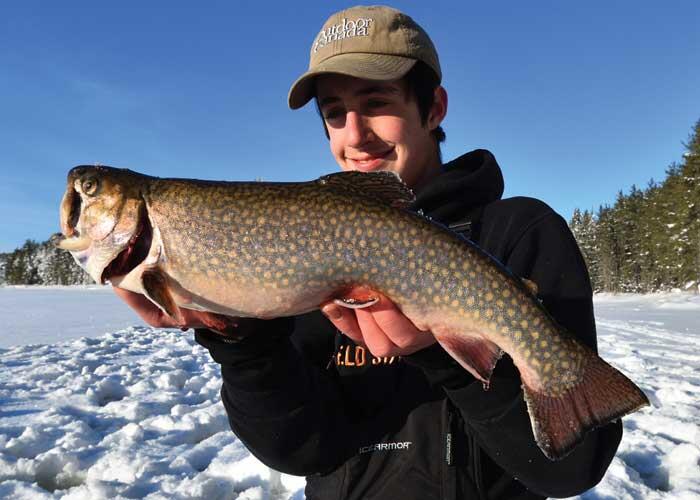 young angler holding trout