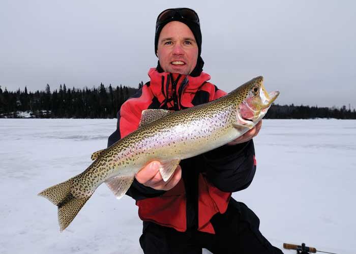 angler with rainbow trout