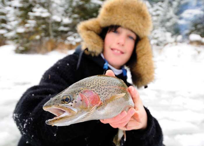 young angler with rainbow trout