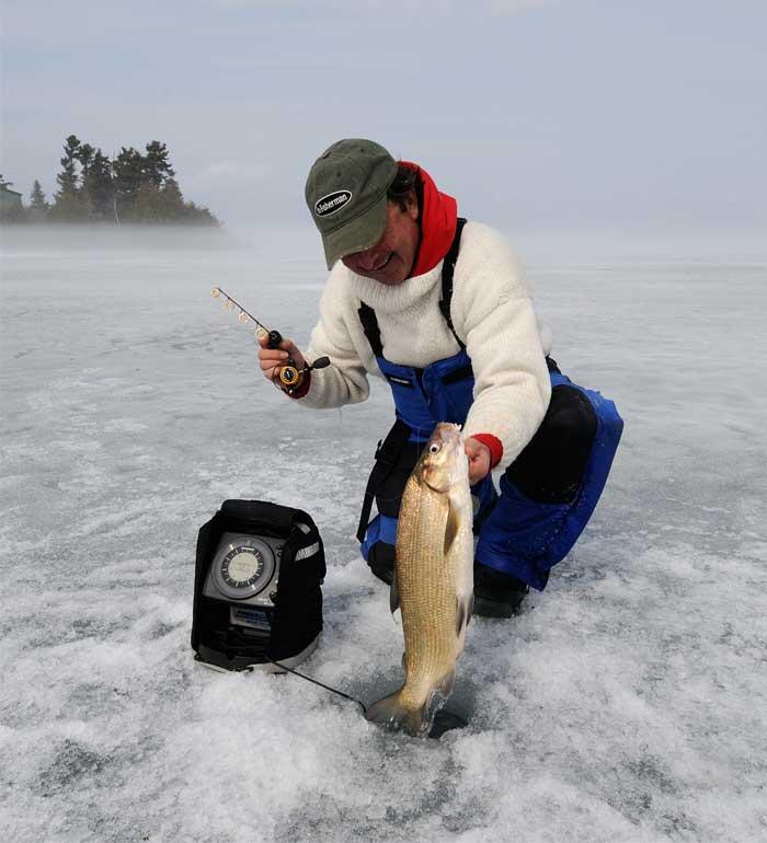 ice angler with whitefish