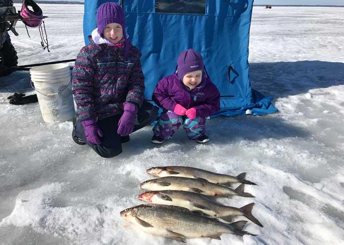 young ice anglers with whitefish