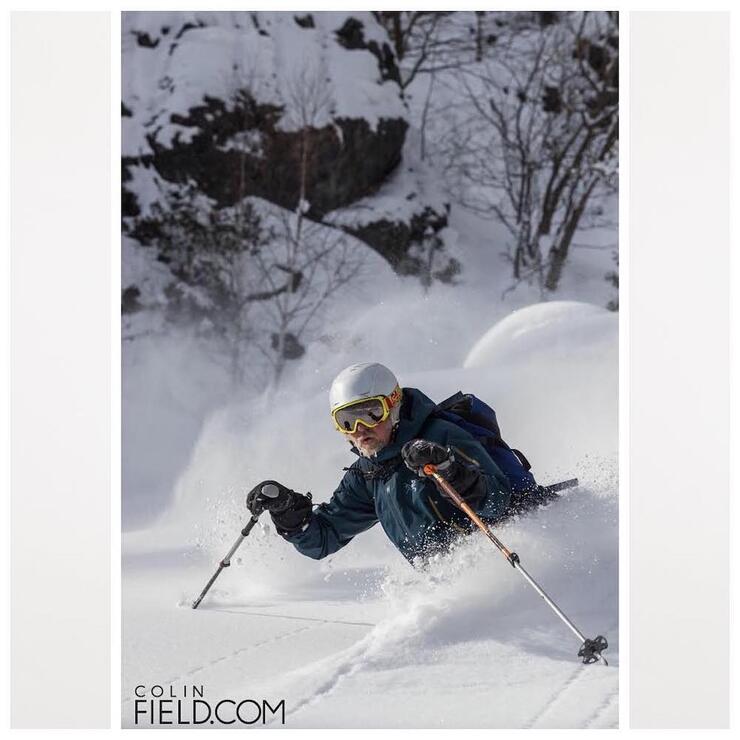 Man downhill skiing in powder snow