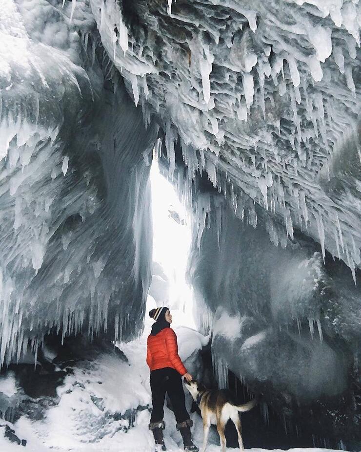 Woman and dog staving in ice cave