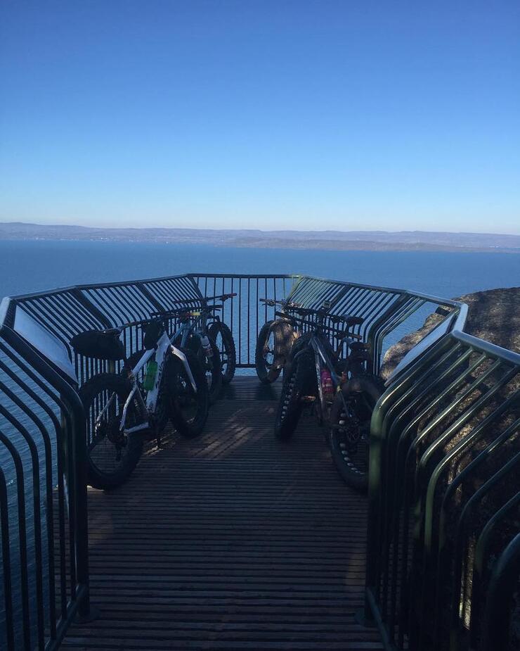 Bikes leaning against railing at a lookout point