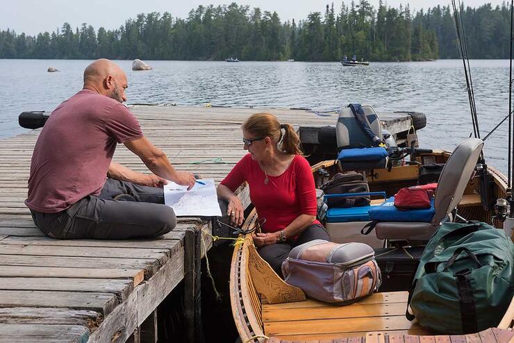 people at dock, fishing boat