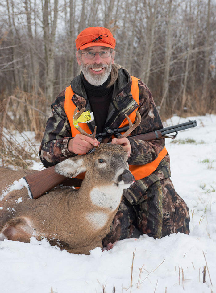 hunter with harvested ontario whitetail deer
