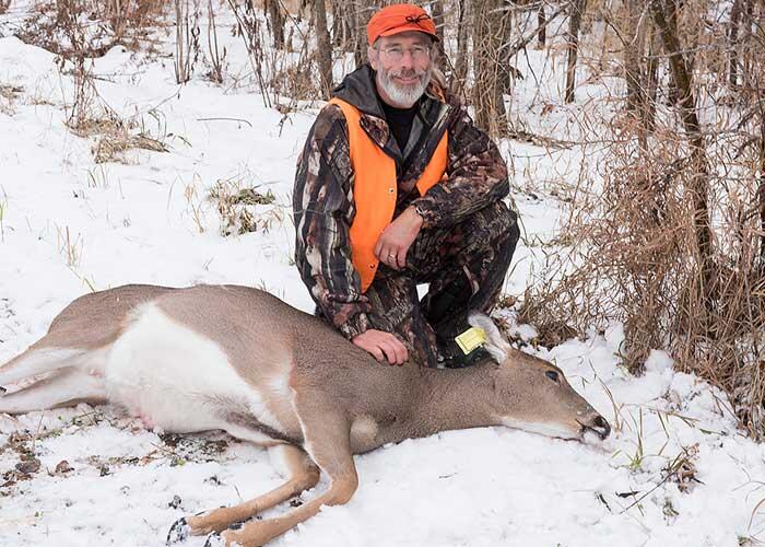 hunter with harvested ontario deer