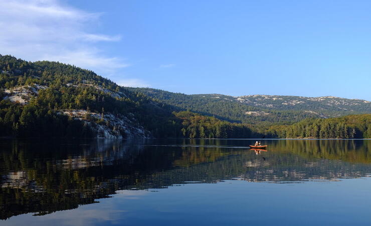 Canoe on lake with La Cloche mountains surrounding