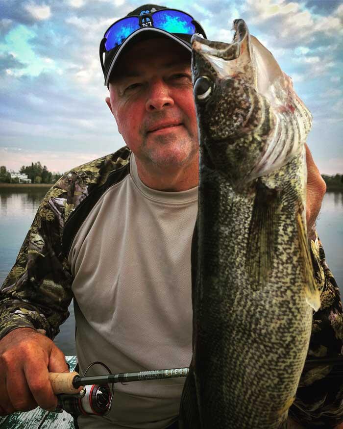 angler holding walleye