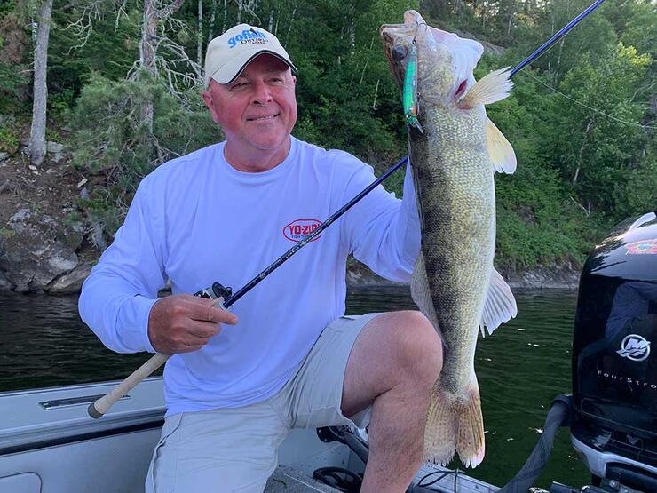 angler holding walleye