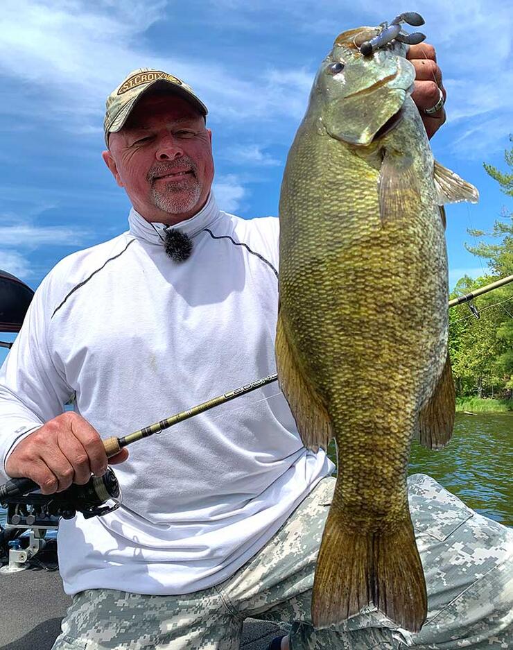 angler holding smallmouth bass