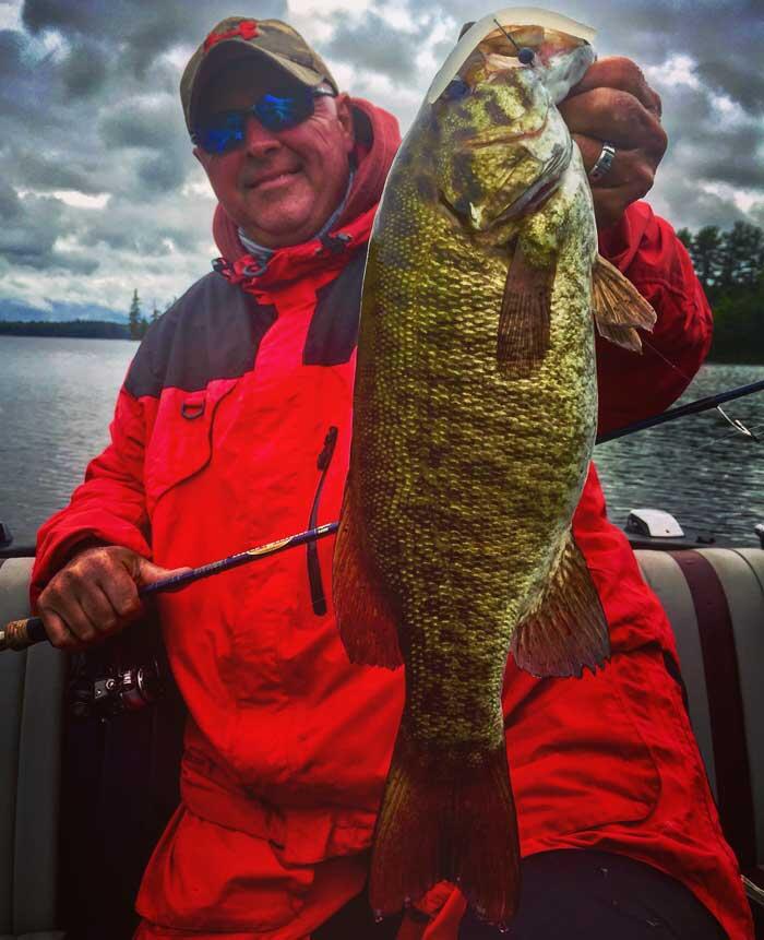 angler holding smallmouth bass