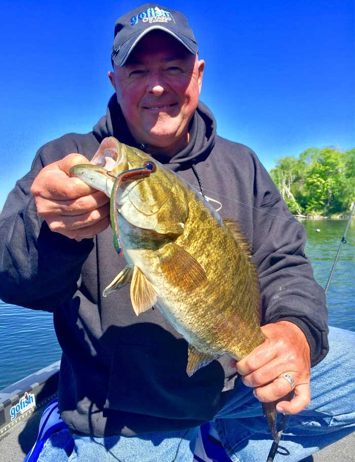 angler holding bass