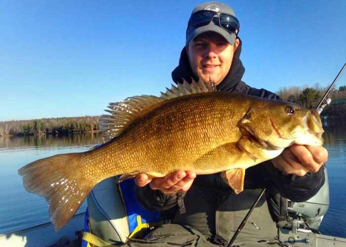 angler holding fall ontario bass