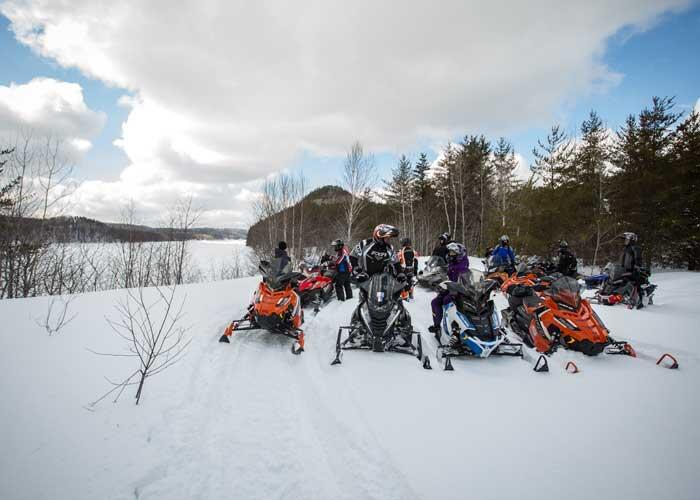 group of snowmobiles on trail