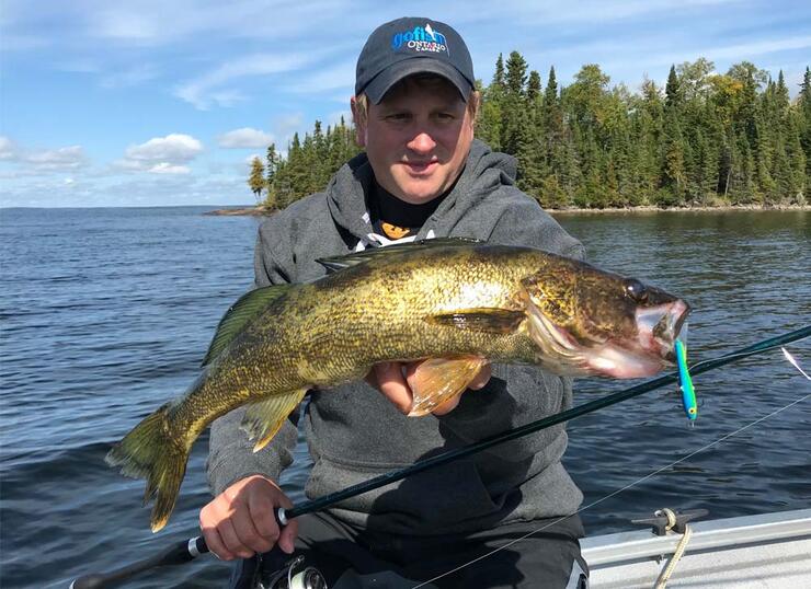 angler holding walleye