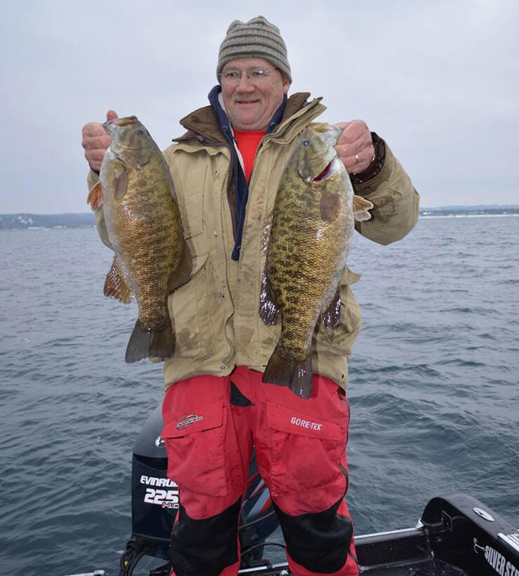 fisherman holding 2 large bass