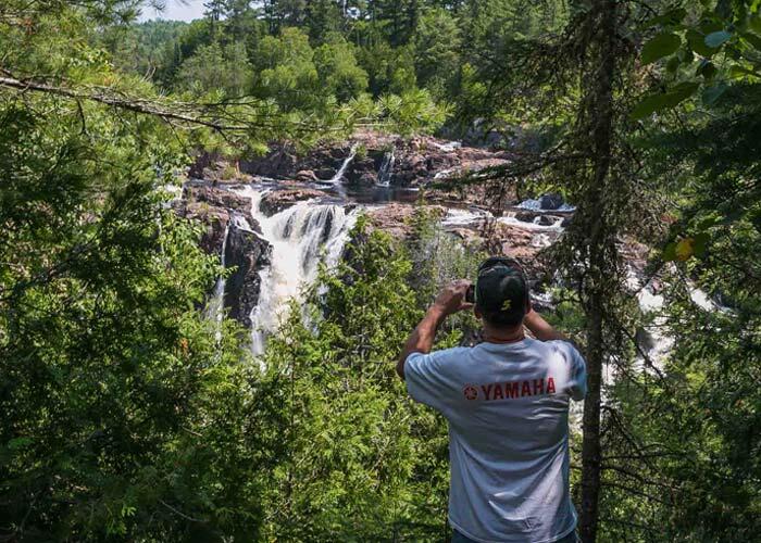 man photographing aubrey falls
