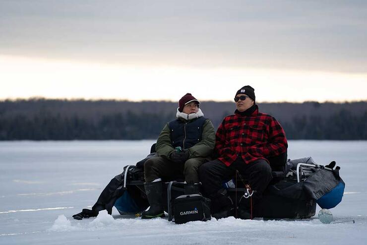 2 ice anglers on frozen lake