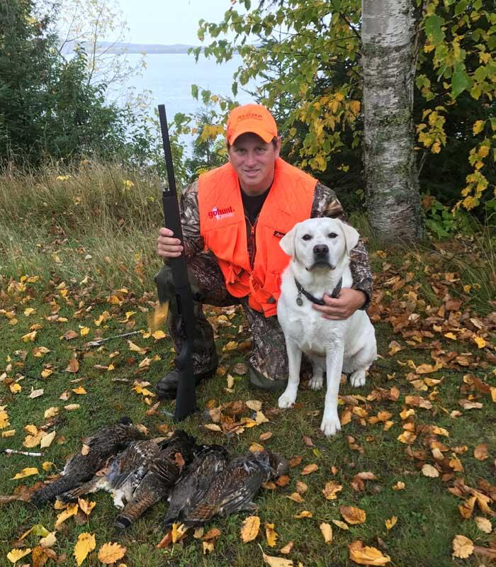 hunter and dog with harvested grouse