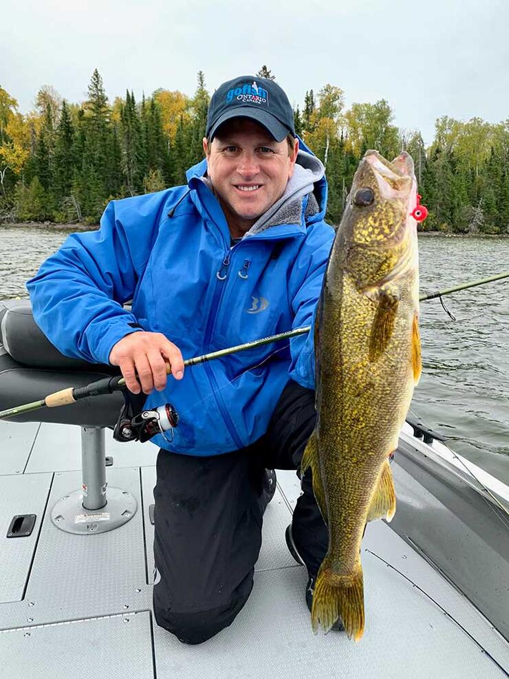 angler holding walleye