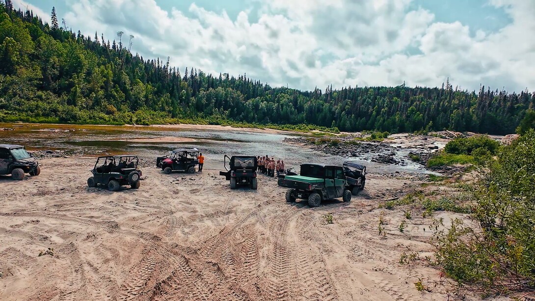 ATVs and side by side by the water in Northern Ontario boreal forest